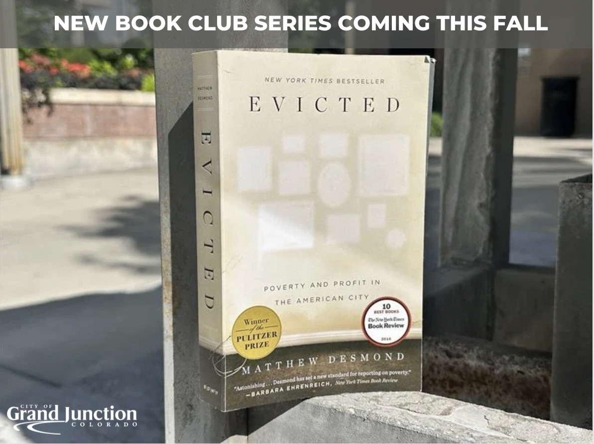 Book sitting against cement statue outside. Text on graphic.