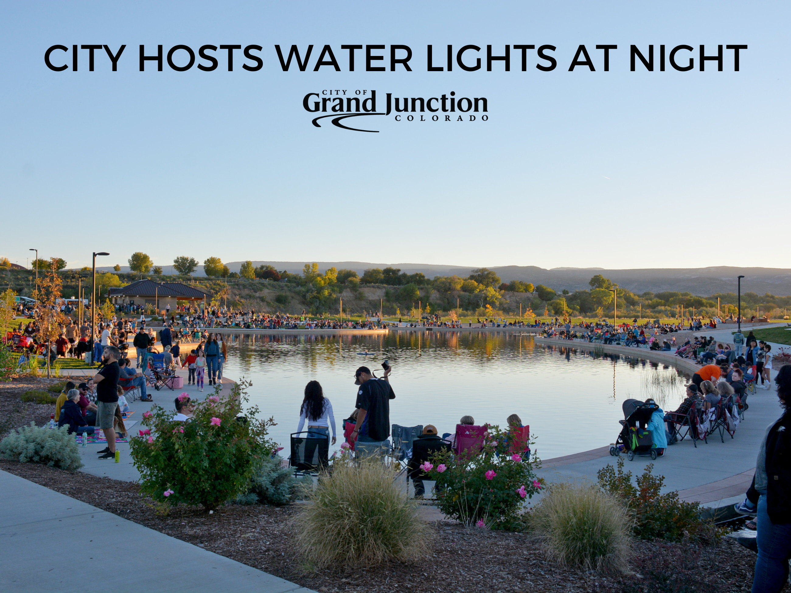 Community members gather around Butterfly Pond for Water Lights at Night