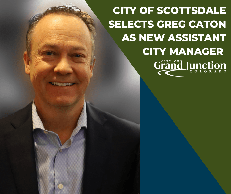 Close up of Greg Caton smiling with a blurred gray background