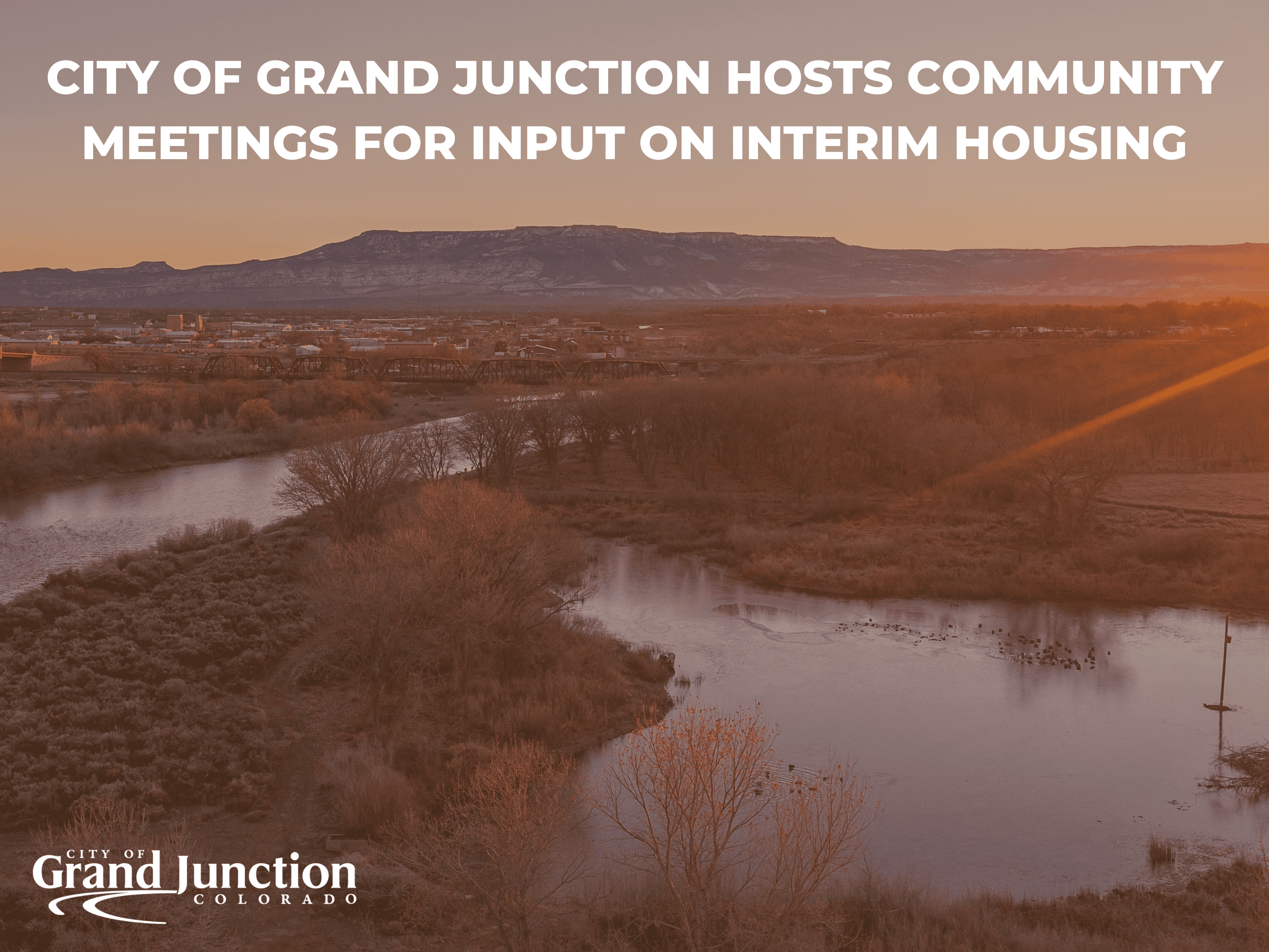 An ariel view of Grand Junction with the mesa in the background. Text on graphic.