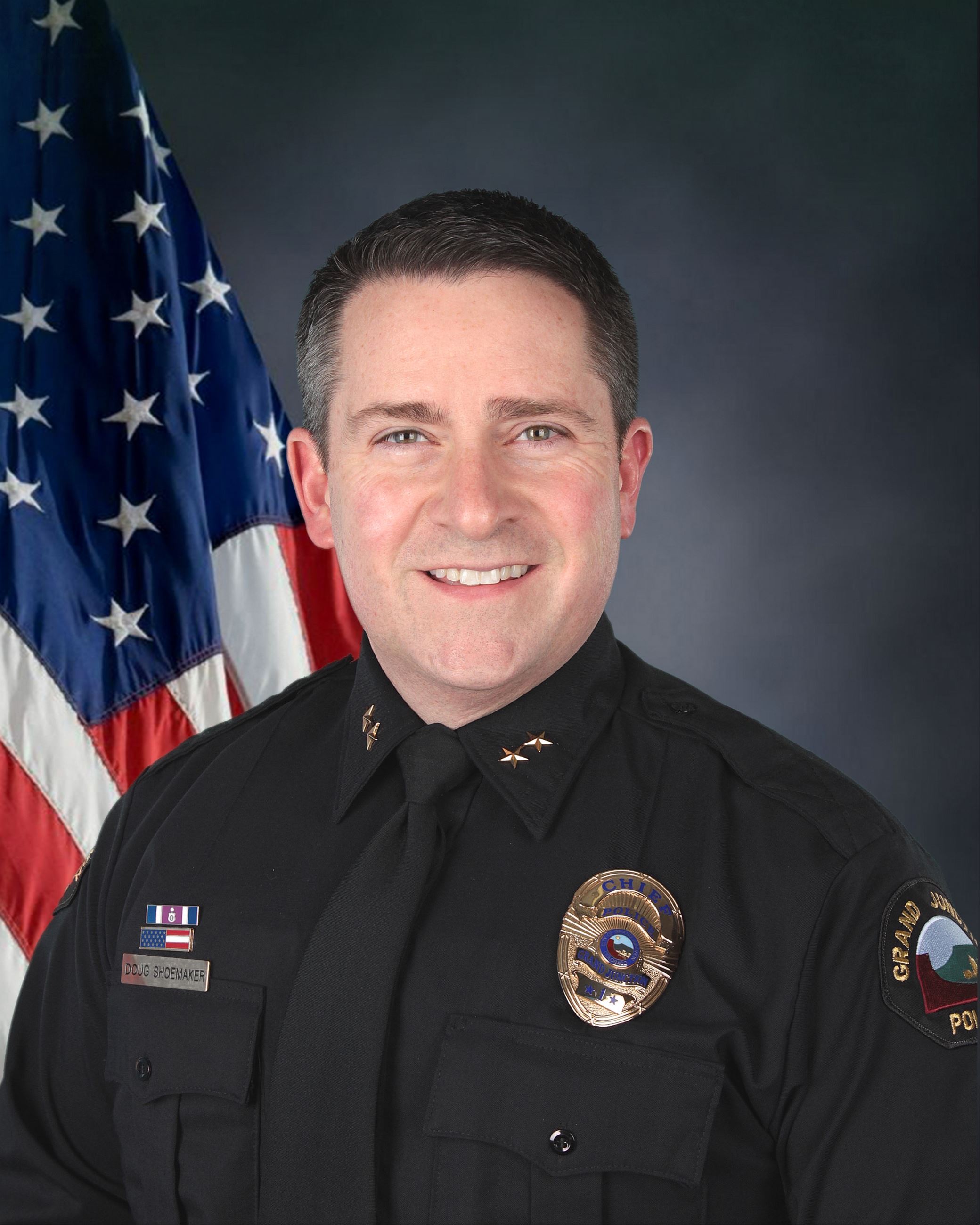 Chief Doug Shoemaker with American flag background