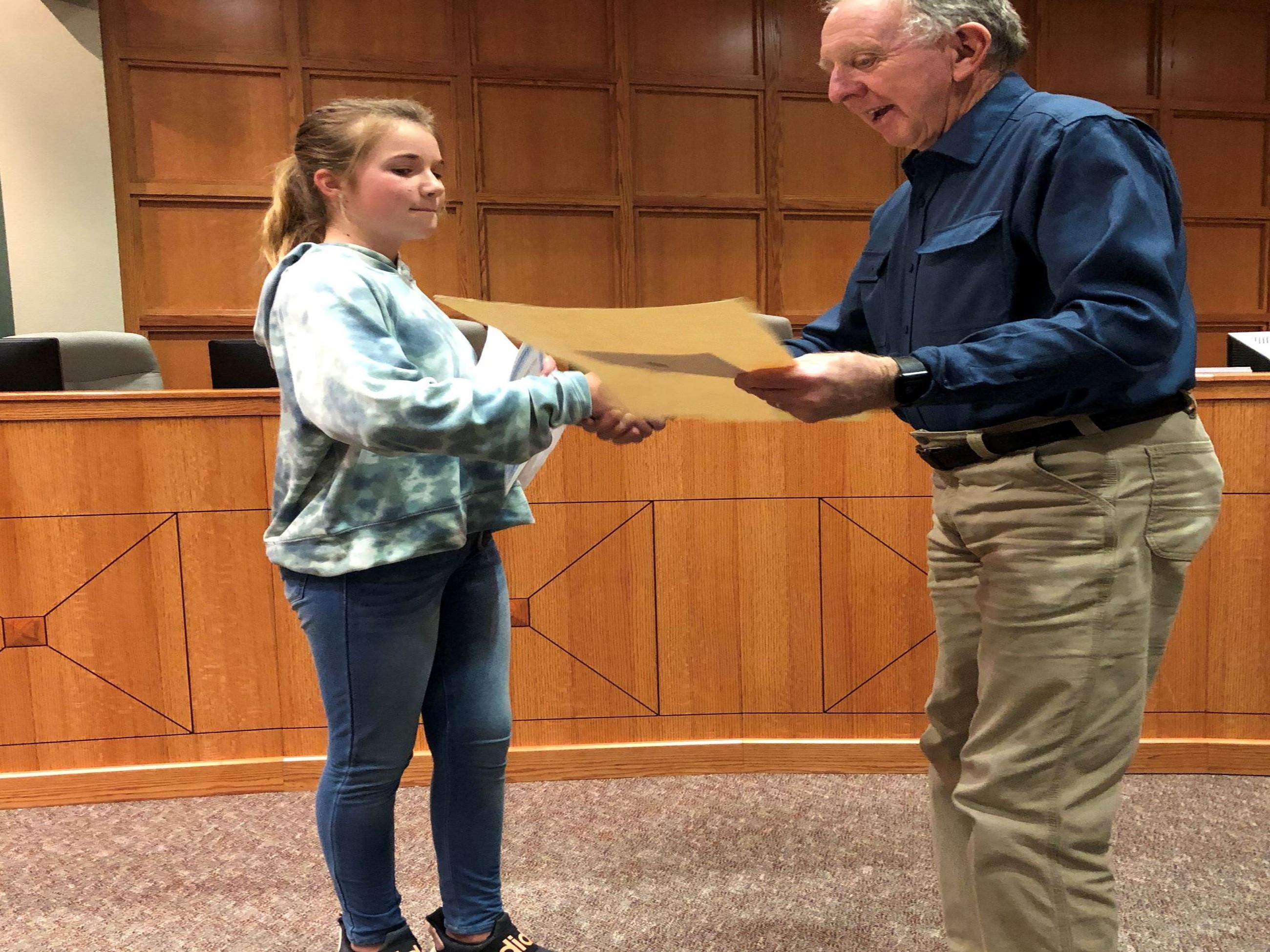 Girl being presented with award