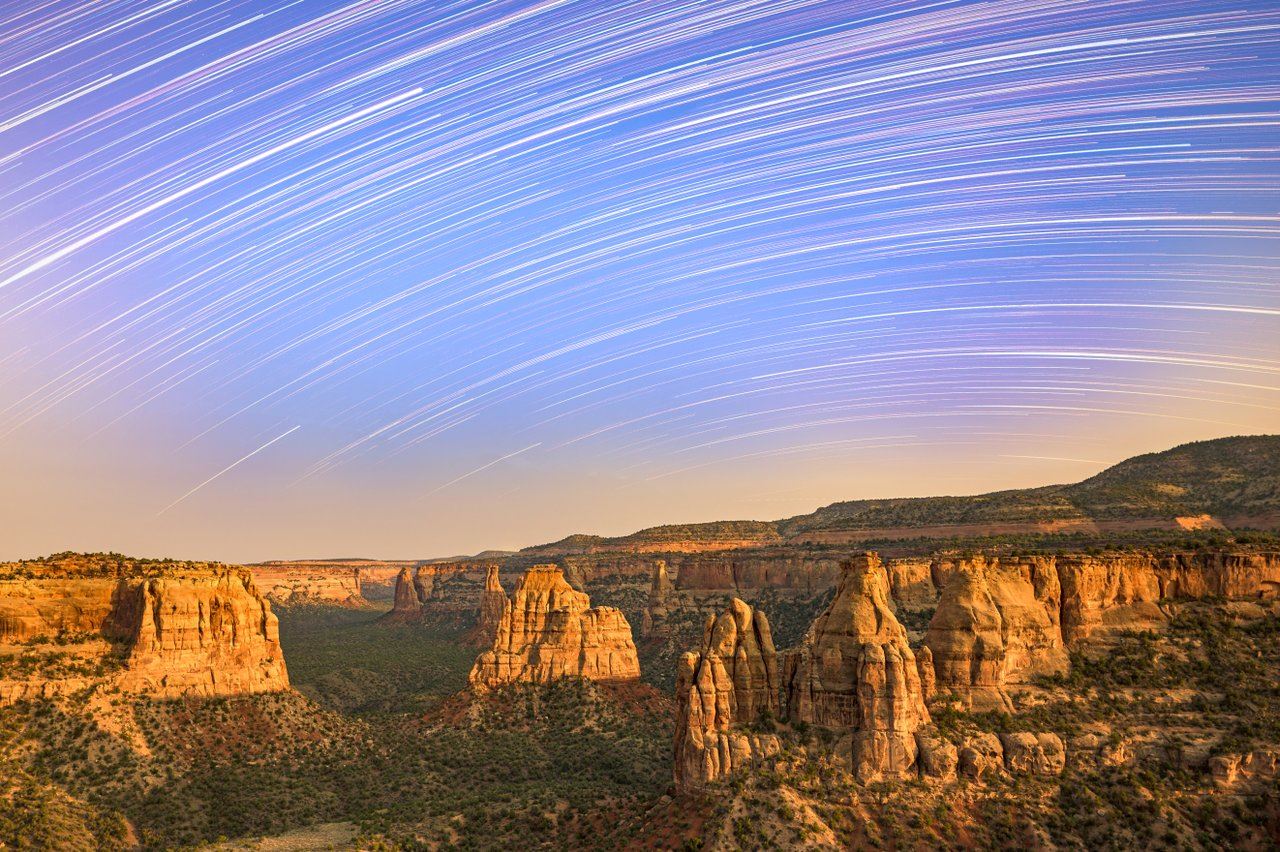 stars in purple sky over red rock