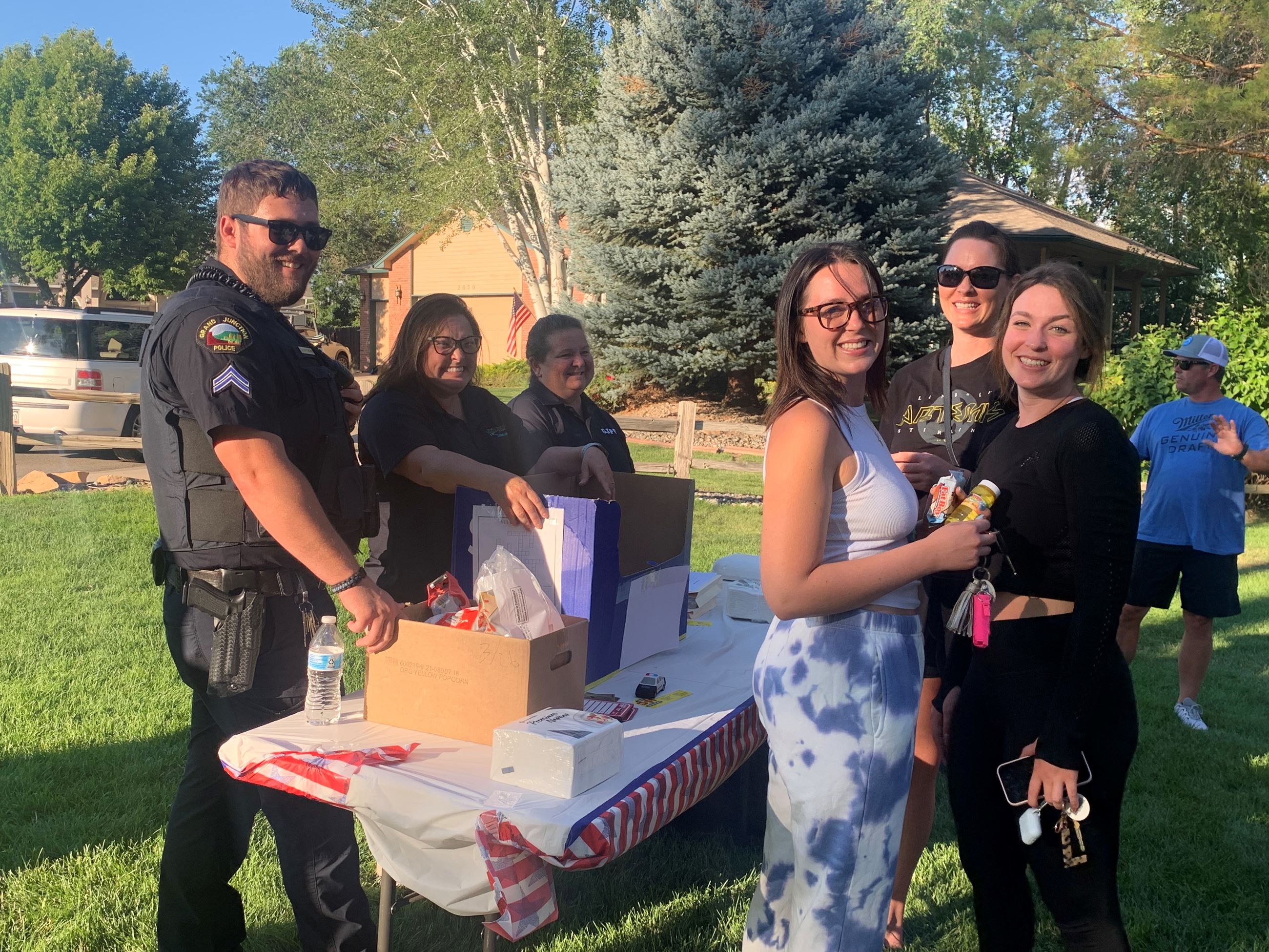 GJPD officers interact with children and families at National Night Out event in park.