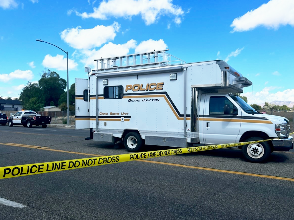 Photo of GJPD Crime Scene Unit, with Police tape surrounding car accident