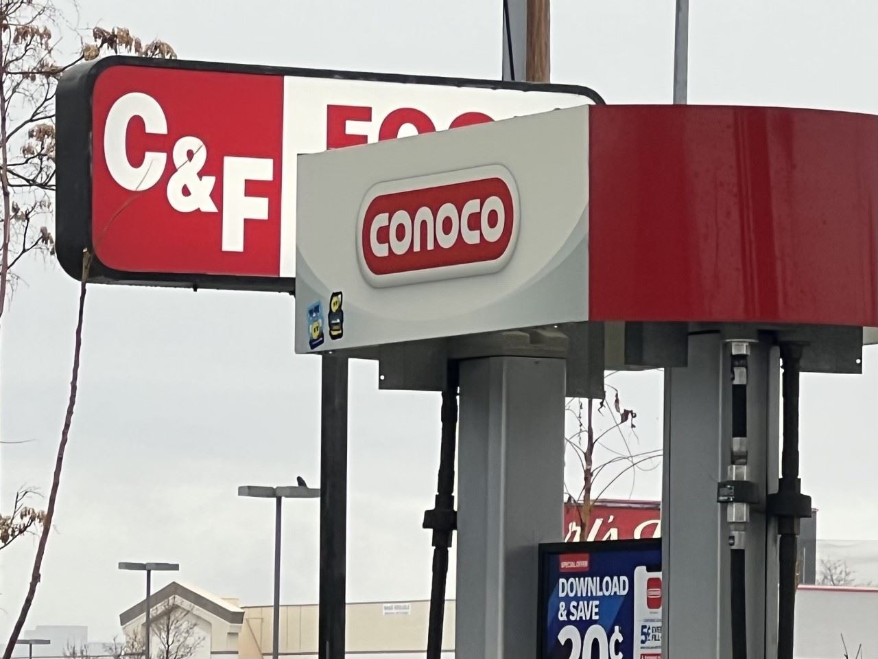 red and white sign of C and F gas station with gas pump
