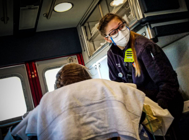EMT provides care to a patient in an ambulance