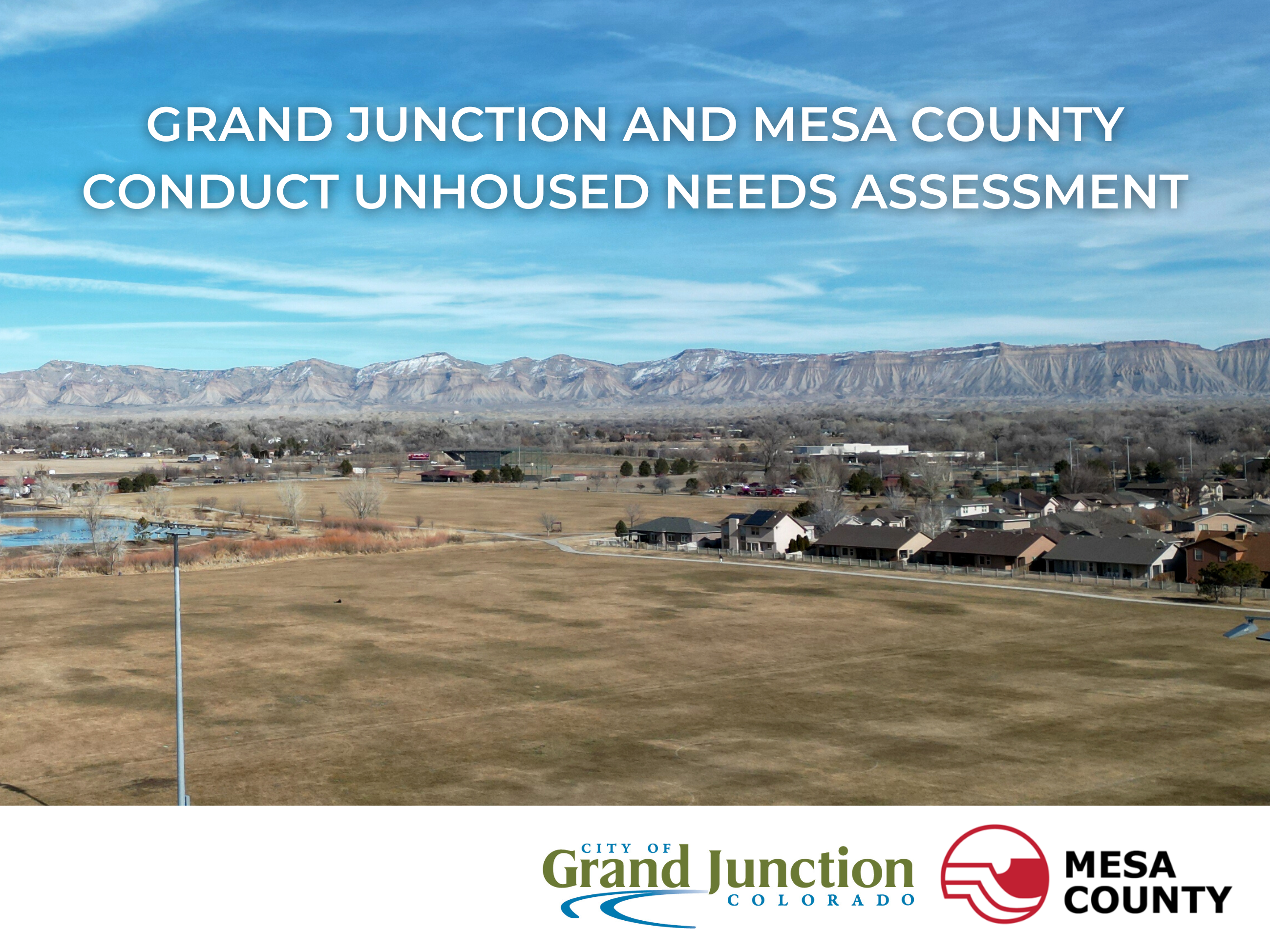 Landscape showing Mount Garfield in the background with grass lawns. Multiple houses shown.