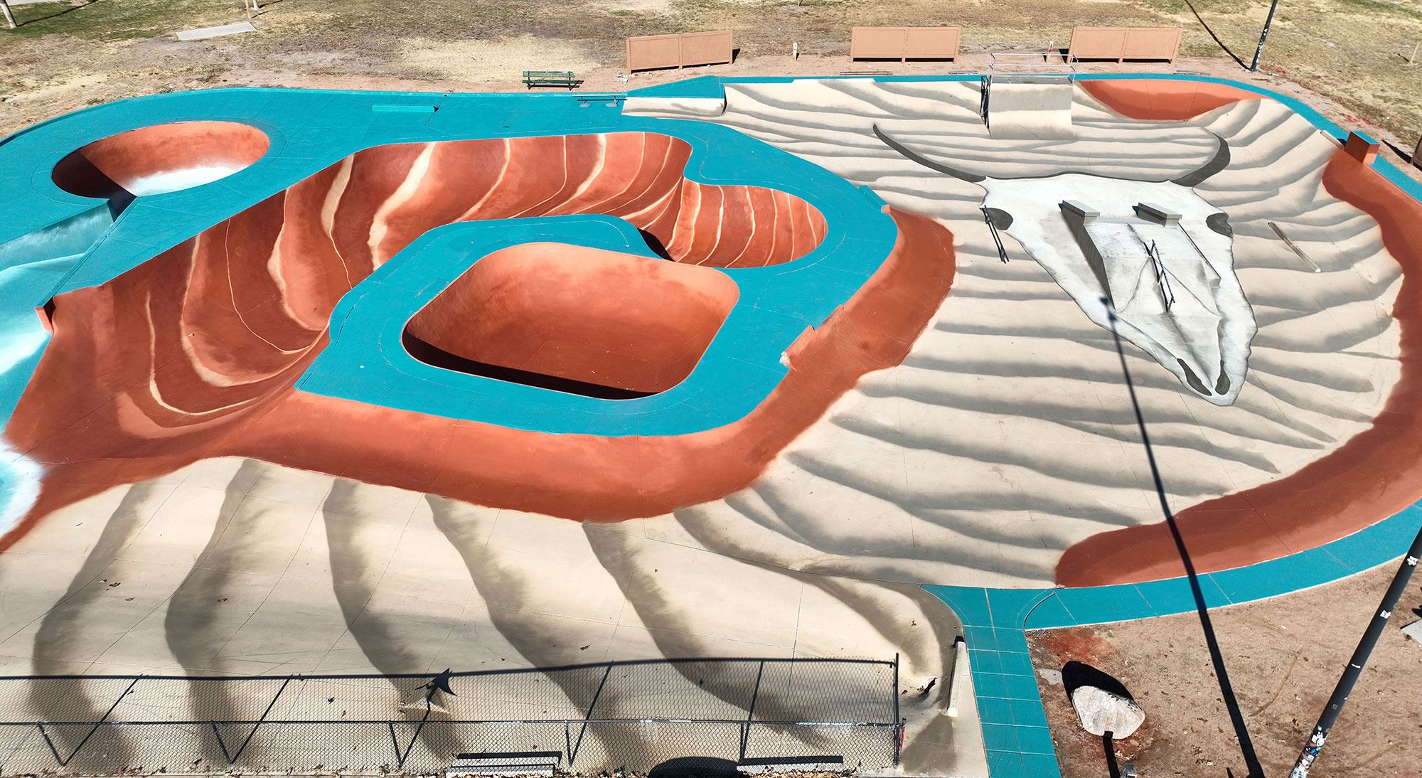 Mural at Westlake Skate Park featuring sand dunes and canyons with a large cow skull