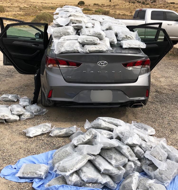Sedan with seized bags of drugs